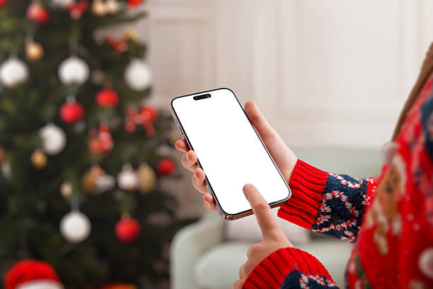 istock Christmas-themed phone mockup with hand tapping the screen, perfect for mobile app previews, winter marketing, festive designs and holiday promotions 2249020235