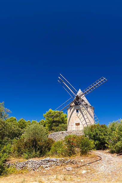 istock Stone windmill standing in Provence against blue sky 2249020275