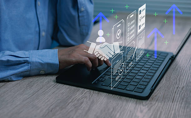istock Businessman using laptop with digital handshake, documents upward arrows symbolizing online collaboration, business growth, digital workflow increasing productivity modern workplace systems concepts 2249020854