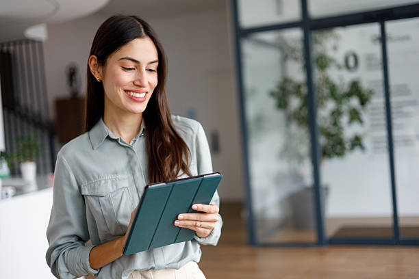 istock Smiling businesswoman using digital tablet in modern office, staying connected and productive 2249023385