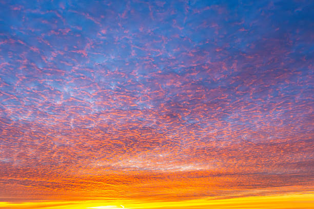 istock Altocumulus blue, pink, orange clouds at twilight. Texture, background. 2249023430