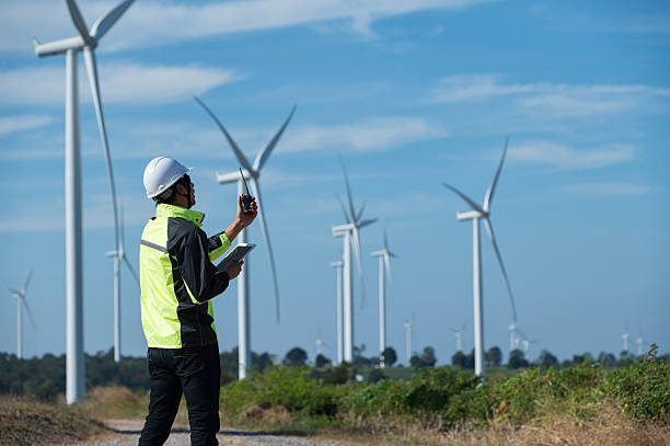 istock Engineer Inspecting Wind Turbine with Digital Tablet at Renewable Energy Farm 2249025037