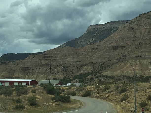 istock Scenic Winding Road Through Rugged Mountains Under a Dramatic Sky in a Remote Rural Area 2249026317
