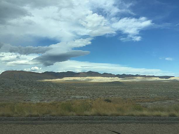 istock Mountains Rise Under a Sweeping Sky Filled With Clouds and Warmth Across the Vast Desert Landscape in the Afternoon Light 2249026354