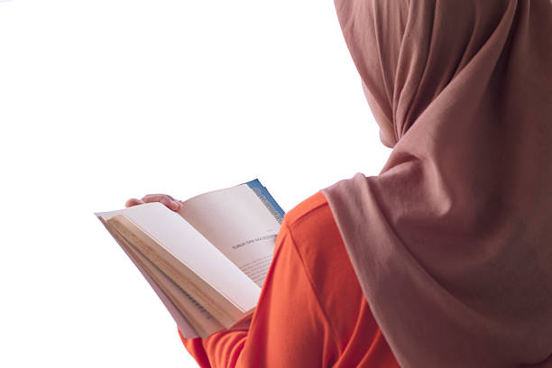 Young asian girl reading book outdoor