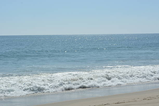 istock Sparkling Waves Gently Lap the Shore on a Sunny Day by the Coast 2249031203