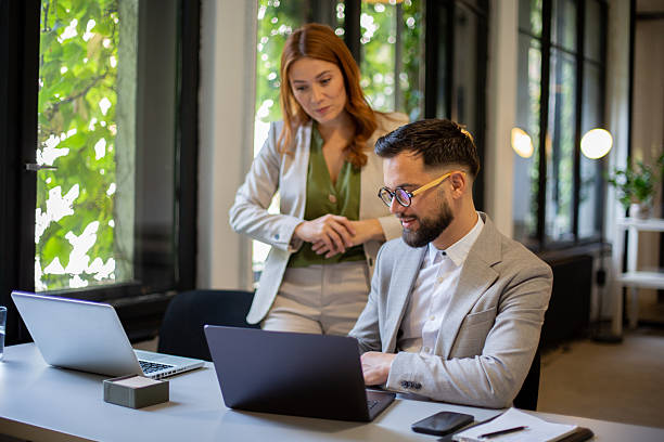 istock Business colleagues collaborating on laptop in modern office 2249031521