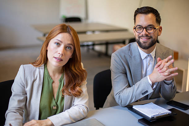 Two diverse business people working together in a corporate office setting