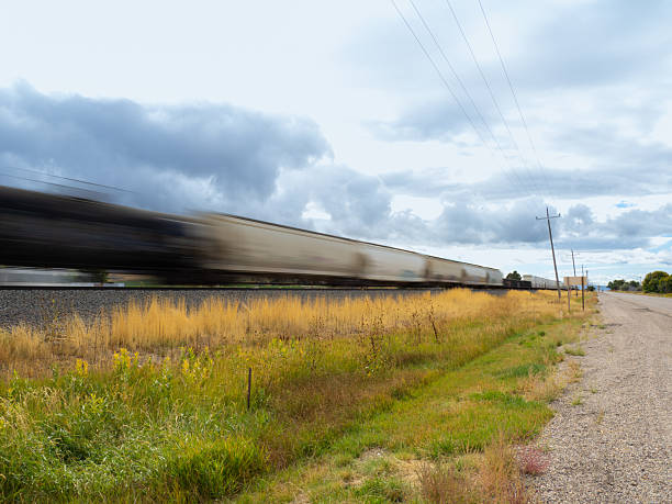 istock Blur of a speeding freight train passing by a rural road in Cache Valley 2249033852