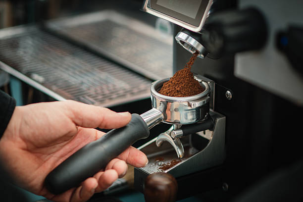 istock Freshly ground coffee falling into portafilter from espresso grinder 2249042403