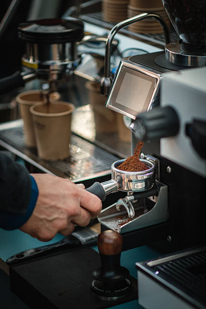 istock Freshly ground coffee falling into portafilter from espresso grinder 2249042423