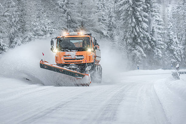 istock Snow plow clear and sprinkles snowy road in a snowstorm. 2249043494