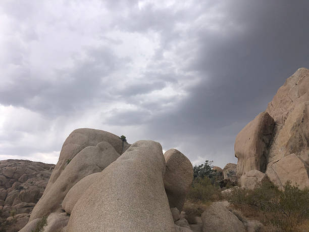 istock Dramatic Clouds Loom Over Unique Rock Formations in a Desert Landscape During an Afternoon Hike 2249046134