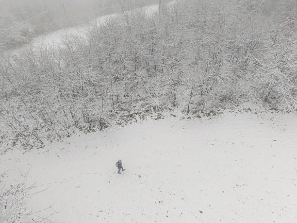 Adult man get away from it all in snowy mountain and forest for weekend to relax in nature
