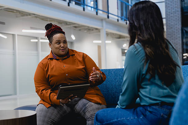 istock Diverse Female Co-workers Meet to Discuss Project 2249047779