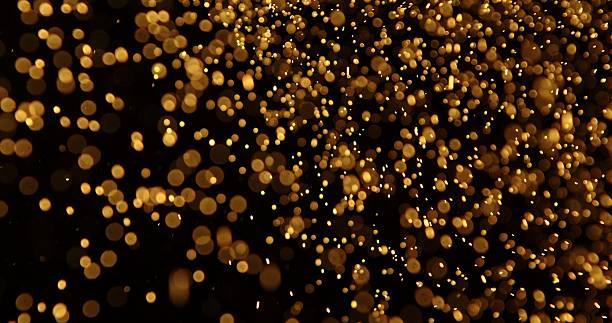 istock Abstract particles of gold dust float in the air 2249053066