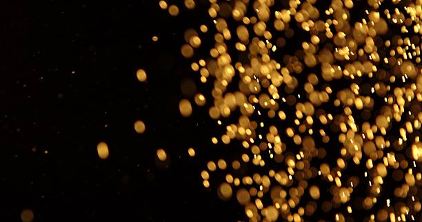 istock Abstract particles of gold dust float in the air 2249053352