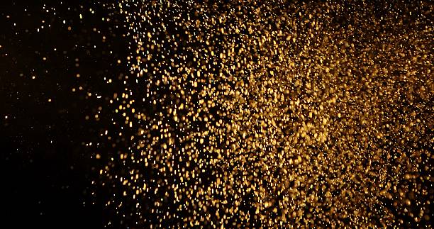 istock Abstract particles of gold dust float in the air 2249054510