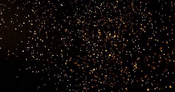 istock Abstract particles of gold dust float in the air 2249054734