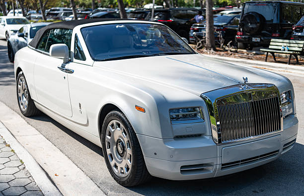 Miami, Florida, USA - April 13, 2025: 2016 Rolls Royce Phantom Drophead Coupe convertible car. Luxury convertible car Rolls Royce Phantom. Car Rolls Royce Phantom parked. White car, corner view.