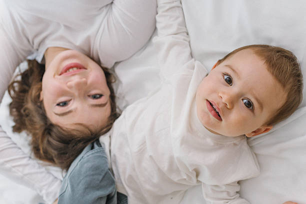 istock Happy mother and baby lying together on a soft 2249060383
