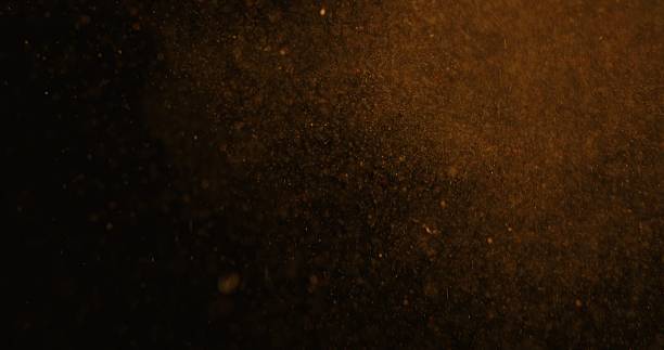 istock Abstract particles of gold dust float in the air 2249063083