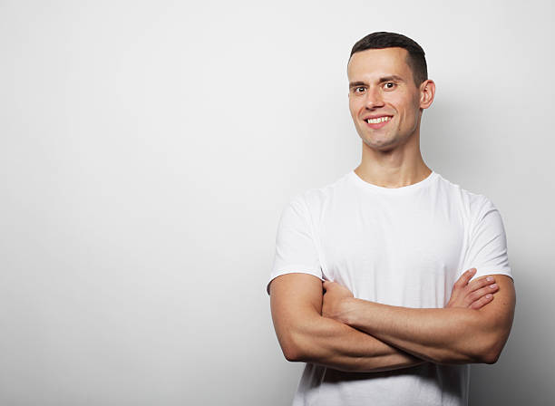 istock Lifestyle, emotion and people concept: handsome young man looking at camera on grey background 2249068337