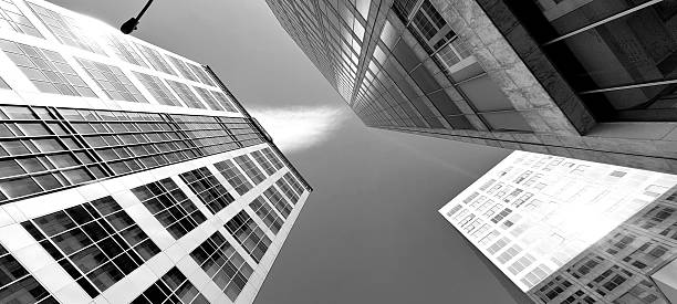 istock Dramatic Low-Angle View of Modern Glass Office Towers Converging, Black and White 2249071989