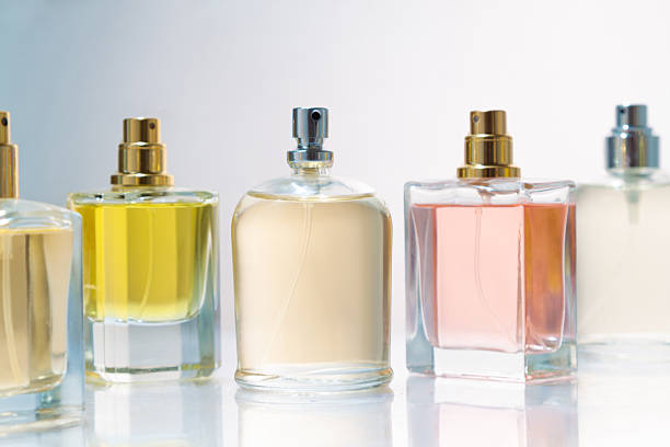 istock An assortment of perfume bottles sit on a glass shelf on white background. 2249076327