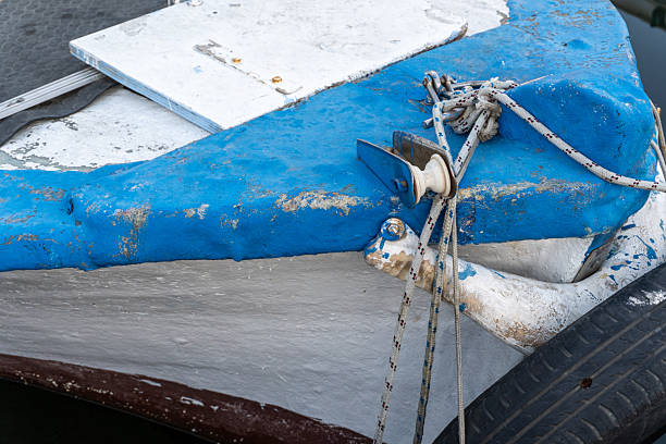 Old fishing boat painted blue and white—weathered wood, gentle charm, resting quietly by the shore.