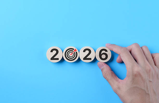 istock 2026 goal setting concept. Hand arranging wooden blocks and target icon on blue background, symbolizing business planning, vision execution, future strategy and performance objectives. 2026 new year, 2249077401
