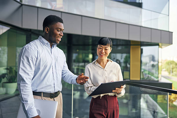 istock Business professionals discussing work on office balcony 2249078329