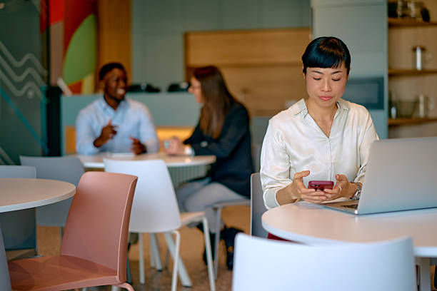 istock Asian woman working on laptop and smartphone in modern office 2249078367