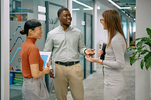 istock Diverse business team discussing projects in modern office hallway 2249078513