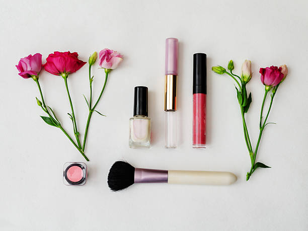 istock Colorful cosmetics arranged with fresh flowers on a neutral background. 2249081023