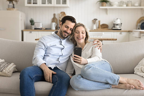 istock Loving couple cuddle on comfy couch take selfie using phone 2249082555