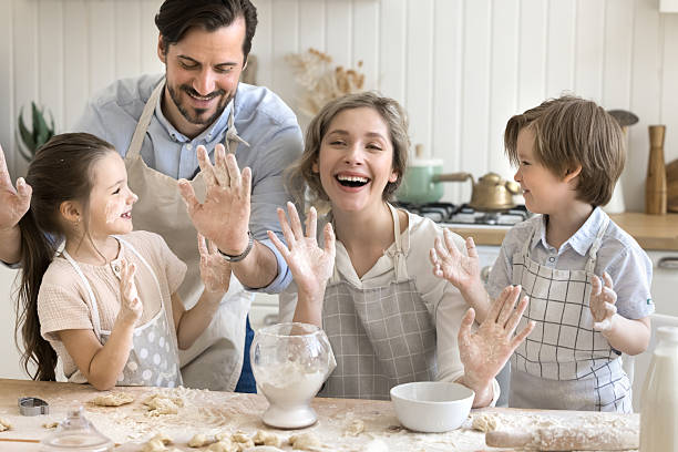 istock Overjoyed parents with little kids cooking clapping hands in flour 2249083421