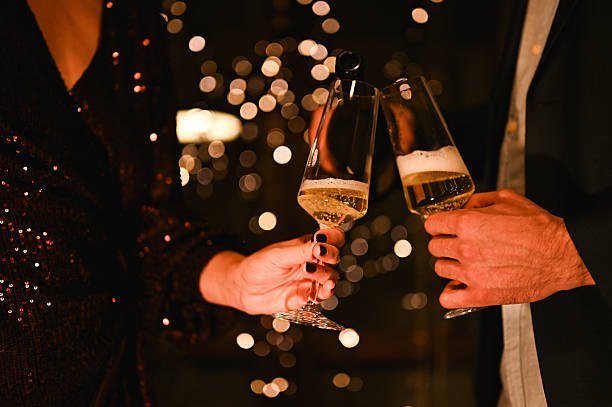 istock Couple toasting champagne during festive celebration with bokeh lights 2249086039