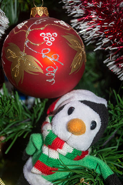 istock Red Ornament and Toy Penguin on Christmas Tree 2249086986