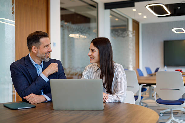 istock Business colleagues collaborating on laptop in modern office, discussing work and sharing ideas 2249090127