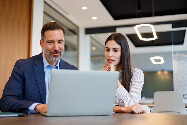 istock Two colleagues analyzing data on a laptop, collaborating on a project in a modern meeting space filled with natural light 2249090396