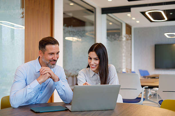 istock Business colleagues collaborating on an important project, discussing strategy in a modern office meeting room, using a laptop 2249092409