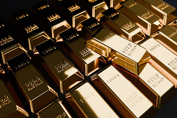 istock Golden bars. Close-up of numerous gold ingots (999.9 fine gold) stacked in rows. Low-key lighting emphasizes luxury, financial stability, banking reserve, and investment scale. 2249092859