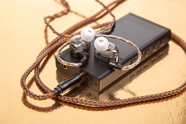 istock High-quality audio player and earphones on a reflective surface 2249097225
