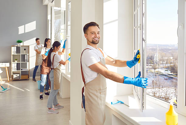istock Male cleaner window washing with squeegee, team working, professional janitor service busy 2249099148