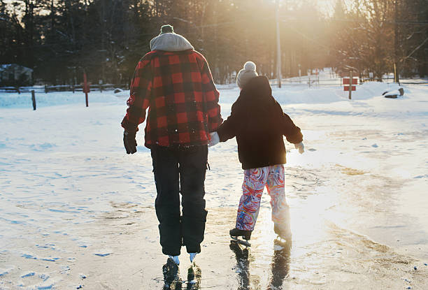 istock Neurodivergent 19-year-old and his 11-year-old sibling practice skating techniques on a frozen frozen lake surface 2249099635