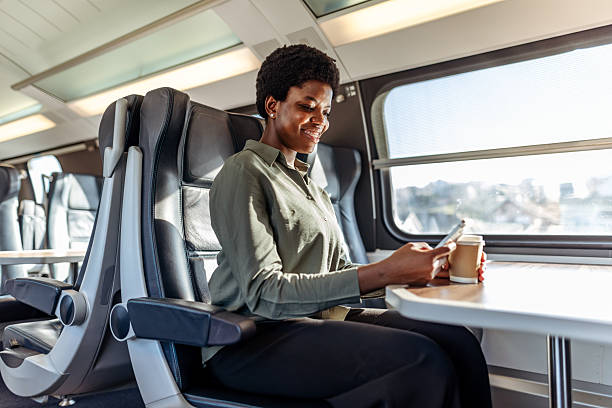 istock Joyful Woman Using Smartphone While Traveling on Modern Public Train 2249099649