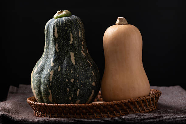 istock Butternut squash in basket on fabric with black background 2249101253