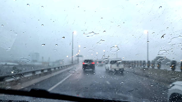 istock Raindrops on the windshield on a rainy evening on the highway. 2249104327