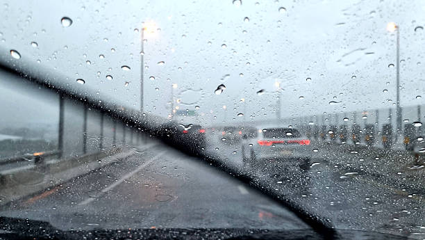 istock Windshield wipers working on the windshield on a rainy day on the highway. 2249104336